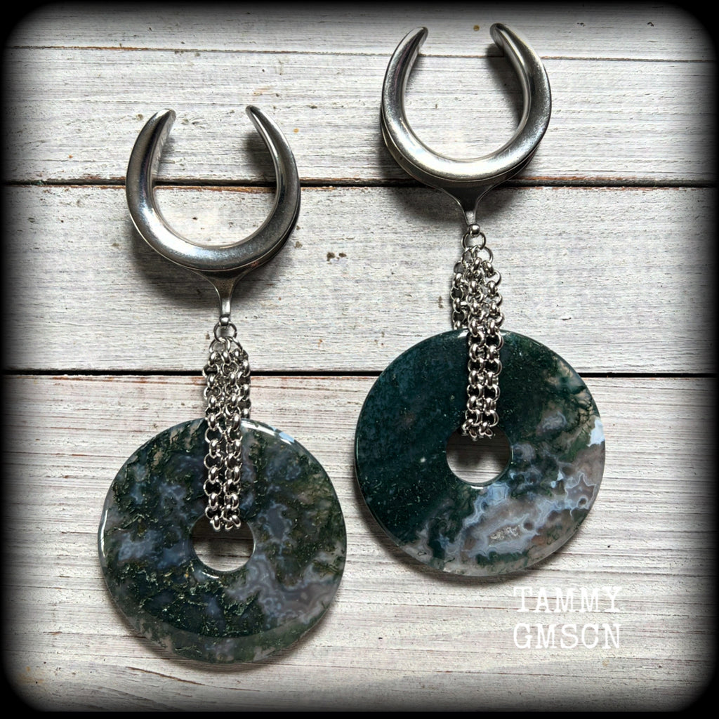 This pair of gorgeous gauged earrings features a pair of unique moss agate gemstone donuts cradled in antique silver chain, weighing approx 39 grams a piece and measuring just over 11cms from tip to tip.

These have been made on 1.18” gauge (30mm) surgical steel cradles, suitable for stretched lobes.