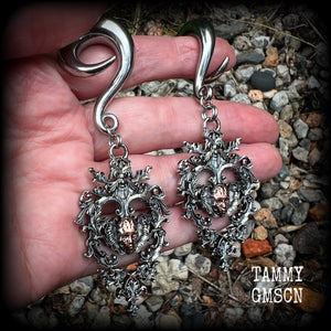 These gorgeous gauged earrings feature the face of a lost soul trapped within the bounds of beautiful baroque antique silver frames, measuring just under 9cms from tip to tip, and weighing approx 33 grams each.

This pair has been made on 00 gauge (10mm) surgical steel full curls, to be worn in stretched lobes.