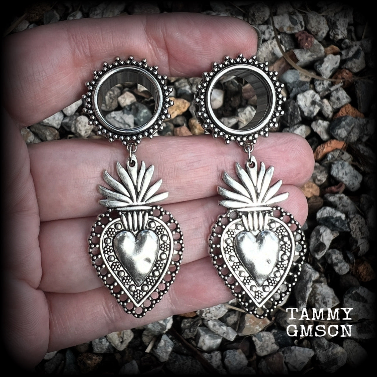 These gorgeous tunnel earrings feature beautiful antique silver sacred hearts, are nice and lightweight, weighing approx 10 grams each and measure just under 7cms from tip to tip.

This pair has been made with 9/16" (14mm) gauge ornate surgical steel screw fit tunnels.