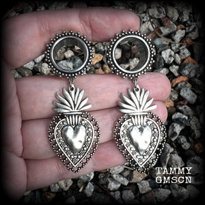 These gorgeous tunnel earrings feature beautiful antique silver sacred hearts, are nice and lightweight, weighing approx 10 grams each and measure just under 7cms from tip to tip.

This pair has been made with 9/16" (14mm) gauge ornate surgical steel screw fit tunnels.