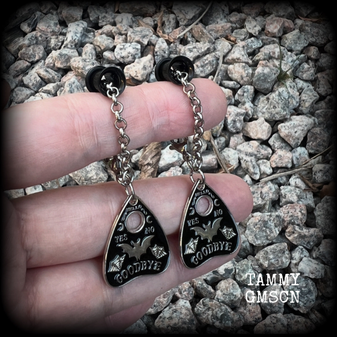 These beautiful antique silver and black enamel tunnel dangles are nice and lightweight and nice and dangly, weighing only 4 grams each, and measuring just over 6cms from tip to tip.

🕷️ PLEASE NOTE-This particular chain will not fit through tunnels smaller than 4 gauge (5mm), though I have lots of different chains that will. Get in touch and we can pick something just for you x

💥This listing includes one pair of surgical steel single flared O-ring earlets. 
