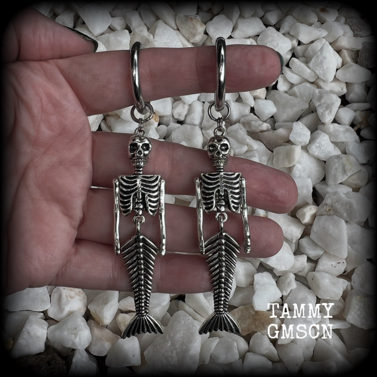 These gorgeous dangly earrings feature antique silver mermaid skeletons, measuring approx 10.5 cms from tip to tip, and weighing approx 14 grams a piece .

These earrings have been made on strong silver alloy snap hoop rings, to be worn in stretched lobes with silicone earlets from 2 gauge (6mm).