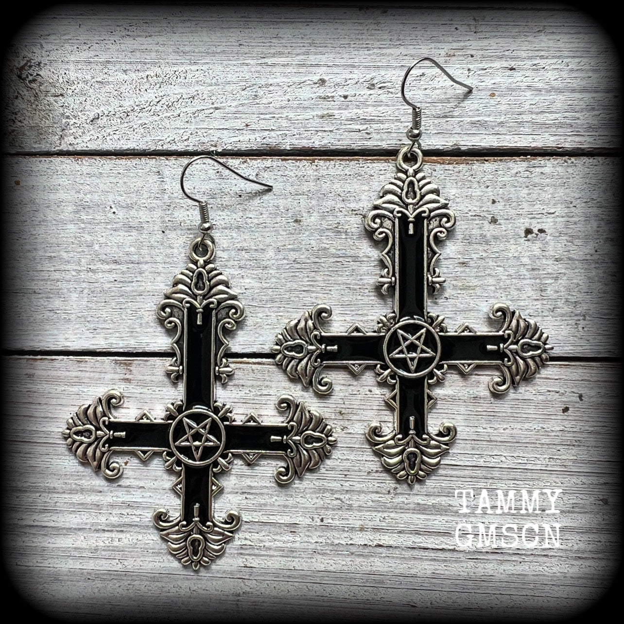 These gorgeous gothic earrings feature a black enamel inverted cross with a silver inverted pentagram, measuring just on 8.5 cms from tip to tip, and weigh approx 10 grams a piece.

This pair have been made on stainless steel french hooks, suitable for pierced ears.