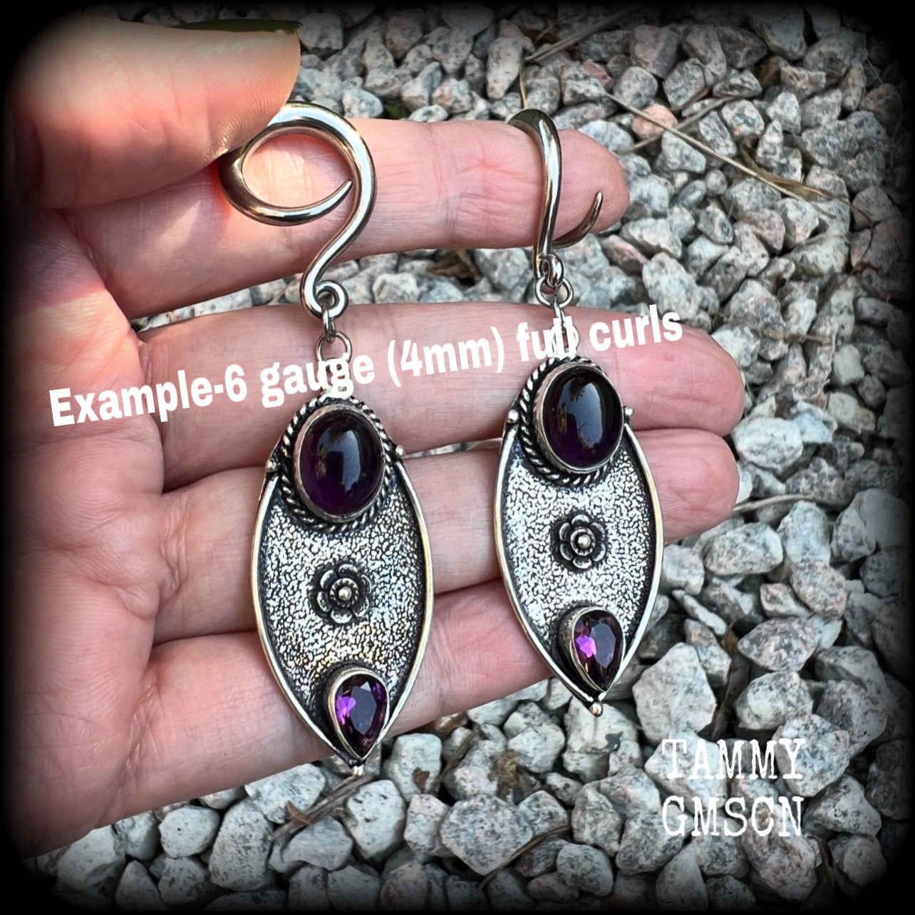 Featuring beautiful purple amethyst gemstones in a boho antique silver setting , this pair of earrings weighs approx 8 grams a piece and measure just under 8cms from tip to tip.

This pair have been made on 6 gauge (4mm) surgical steel full curl hooks, to be worn in stretched lobes.