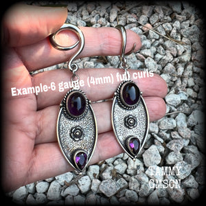 Featuring beautiful purple amethyst gemstones in a boho antique silver setting , this pair of earrings weighs approx 8 grams a piece and measure just under 8cms from tip to tip.

This pair have been made on 6 gauge (4mm) surgical steel full curl hooks, to be worn in stretched lobes.