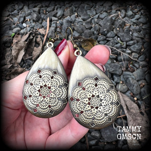 These beautiful teardrop earrings feature an intricate antique bronze mandala, are nice and light weight, weighing 6 grams each, and measuring just on 7 cms from tip to tip.
This pair have been made with antique french hooks, suitable for pierced ears.