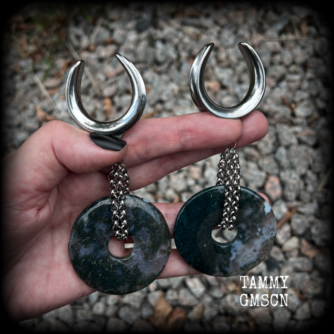 This pair of gorgeous gauged earrings features a pair of unique moss agate gemstone donuts cradled in antique silver chain, weighing approx 39 grams a piece and measuring just over 11cms from tip to tip.

These have been made on 1.18” gauge (30mm) surgical steel cradles, suitable for stretched lobes.