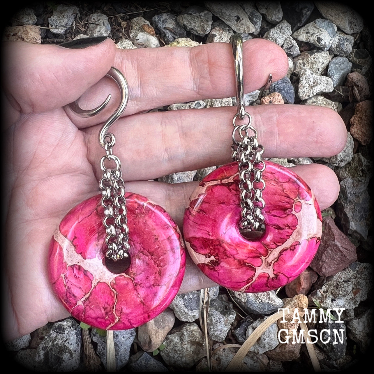 This pair of gorgeous ocean jasper earrings features beautiful pink marbled donut gemstones, weighing approx 19 grams a piece, and measuring 8cms from tip to tip.

This pair has been made on 6 gauge (4mm) surgical steel full curl hooks, to be worn in stretched lobes.