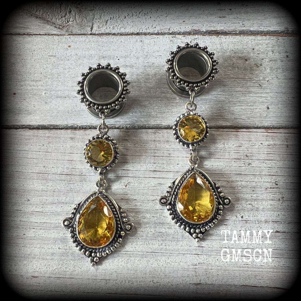 These gorgeous boho tunnel earrings have been made with beautiful yellow citrine gemstones in an antique silver setting, are light weight weighing approx 11 grams each and measure just over 7cms from tip to tip.

This pair have been made with 1/2” gauge (12mm) ornate surgical steel screw fit tunnels, for stretched lobes.
