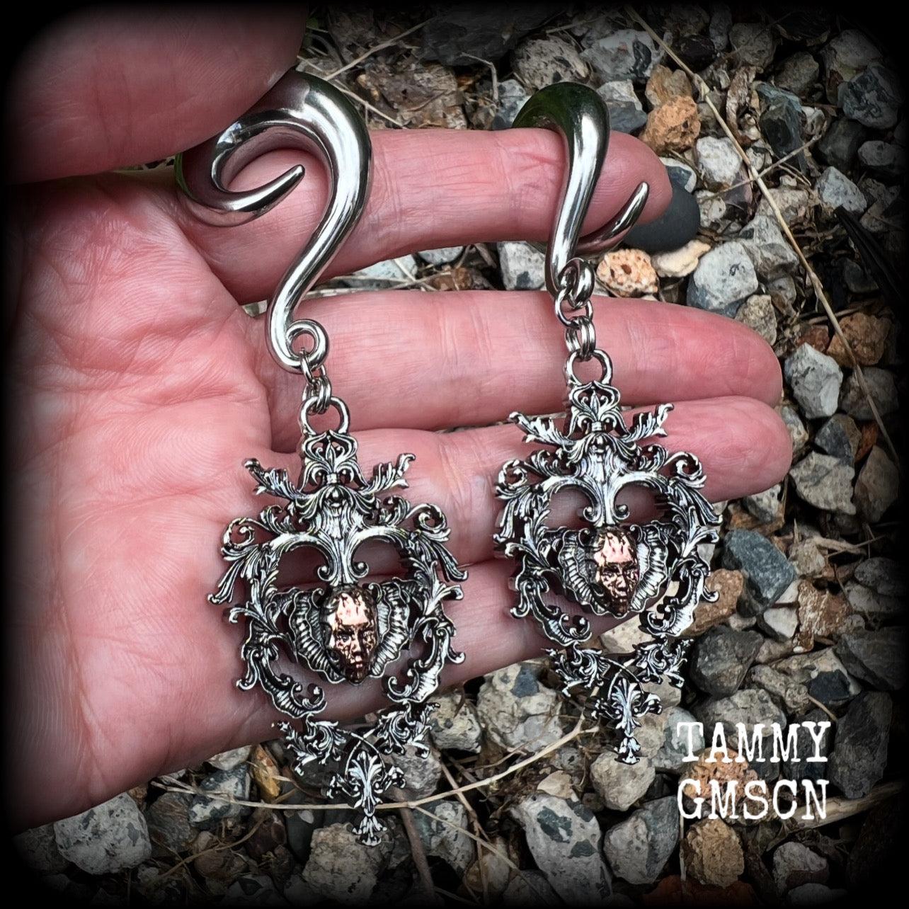These gorgeous gauged earrings feature the face of a lost soul trapped within the bounds of beautiful baroque antique silver frames, measuring just under 9cms from tip to tip, and weighing approx 33 grams each.

This pair has been made on 00 gauge (10mm) surgical steel full curls, to be worn in stretched lobes.