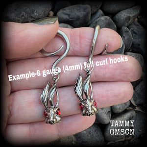 Featuring super cute, slightly creepy antique silver zombie rabbits complete with red eyes, these earrings weigh 7 grams each, and are lovely and dangly at approx 5.5cms from tip to tip.

This pair has been made on 6 gauge (4mm) surgical steel full curl hooks, to be worn in stretched lobes.