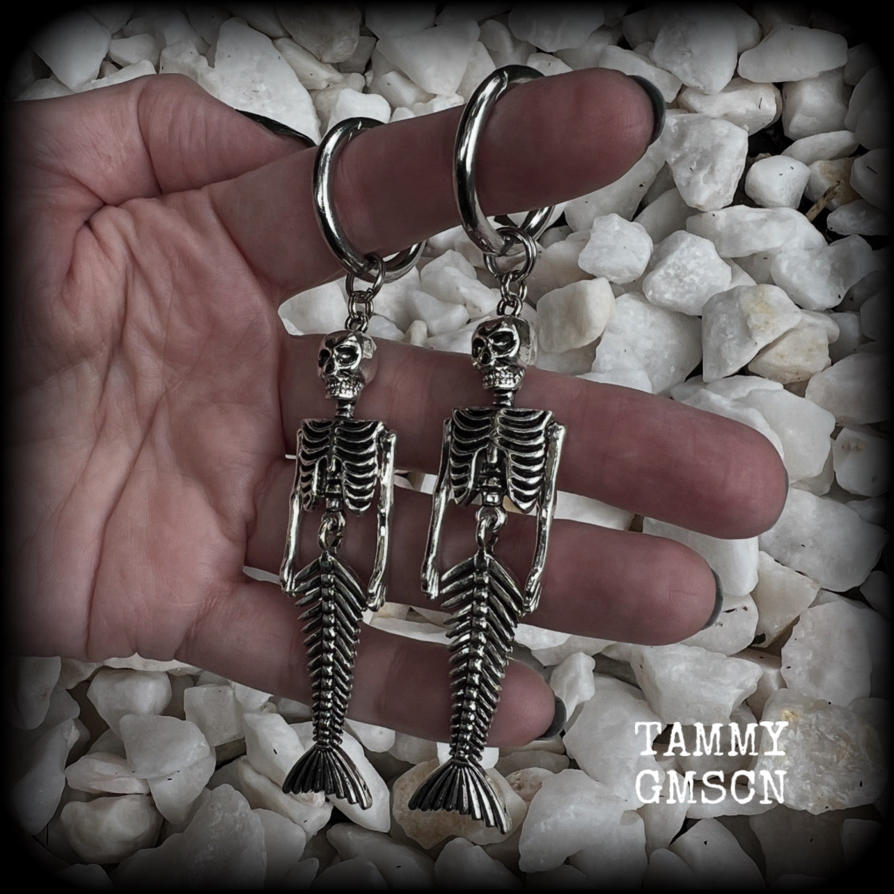 These gorgeous dangly earrings feature antique silver mermaid skeletons, measuring approx 10.5 cms from tip to tip, and weighing approx 14 grams a piece .

These earrings have been made on strong silver alloy snap hoop rings, to be worn in stretched lobes with silicone earlets from 2 gauge (6mm).