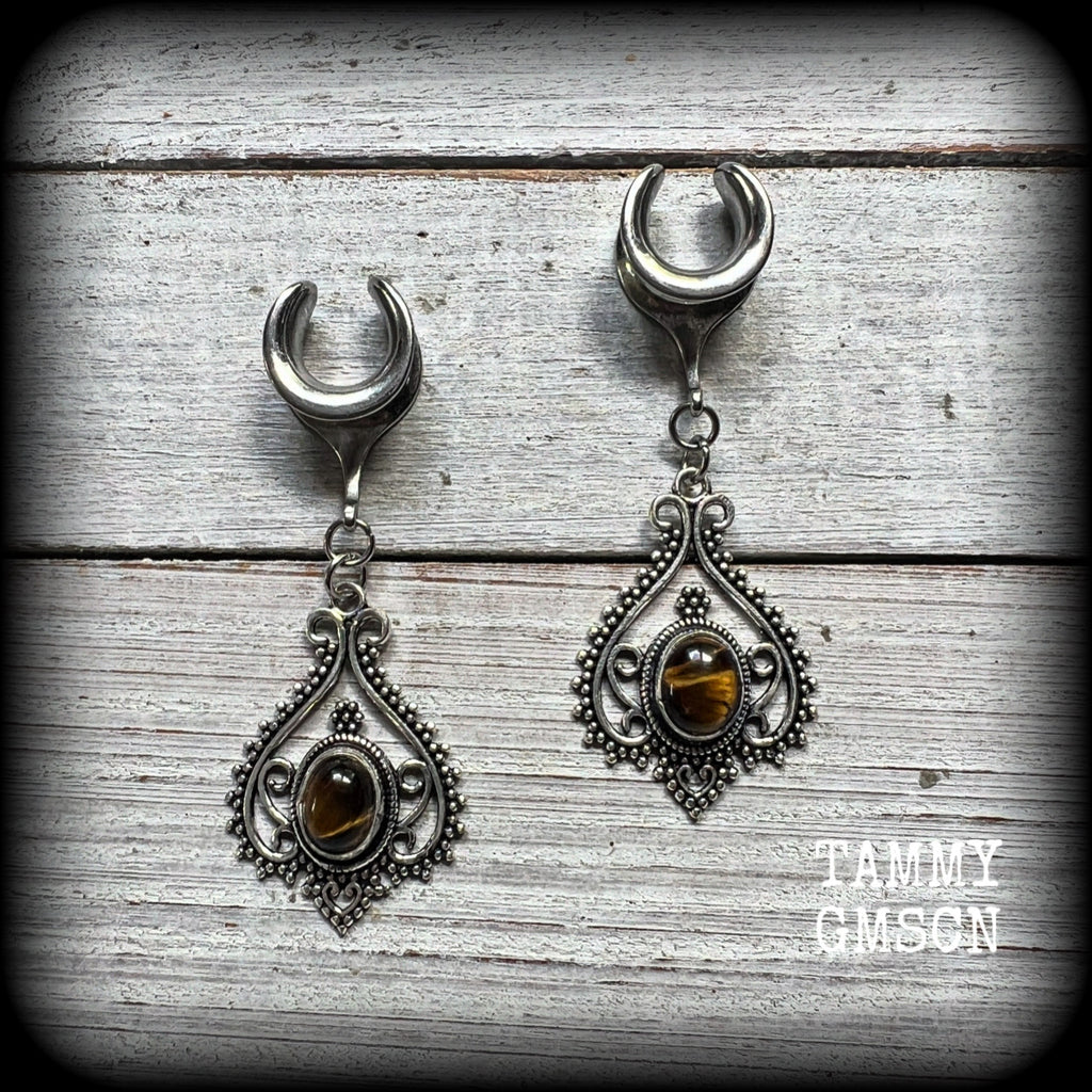 These earrings feature beautiful tigers eye gemstones in a gorgeous boho antique silver setting, lovely and petite at 6cms from tip to tip, and weighing approx 6 grams each.
These earrings have been made on 1/2” gauge (12mm) surgical steel cradles, to be worn in stretched lobes.