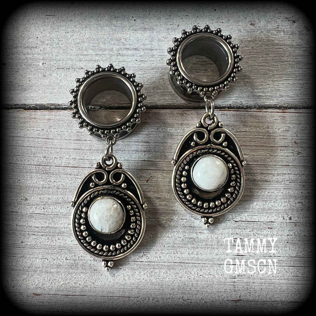 These earrings feature beautiful polished rainbow moonstone gemstones in a gypsy boho antique silver setting, are light weight weighing approx 11 grams each and measuring just on 5.5cms from tip to tip.

This pair has been made with 9/16” gauge (14mm) gauge ornate surgical steel screw fit tunnels, for stretched lobes.