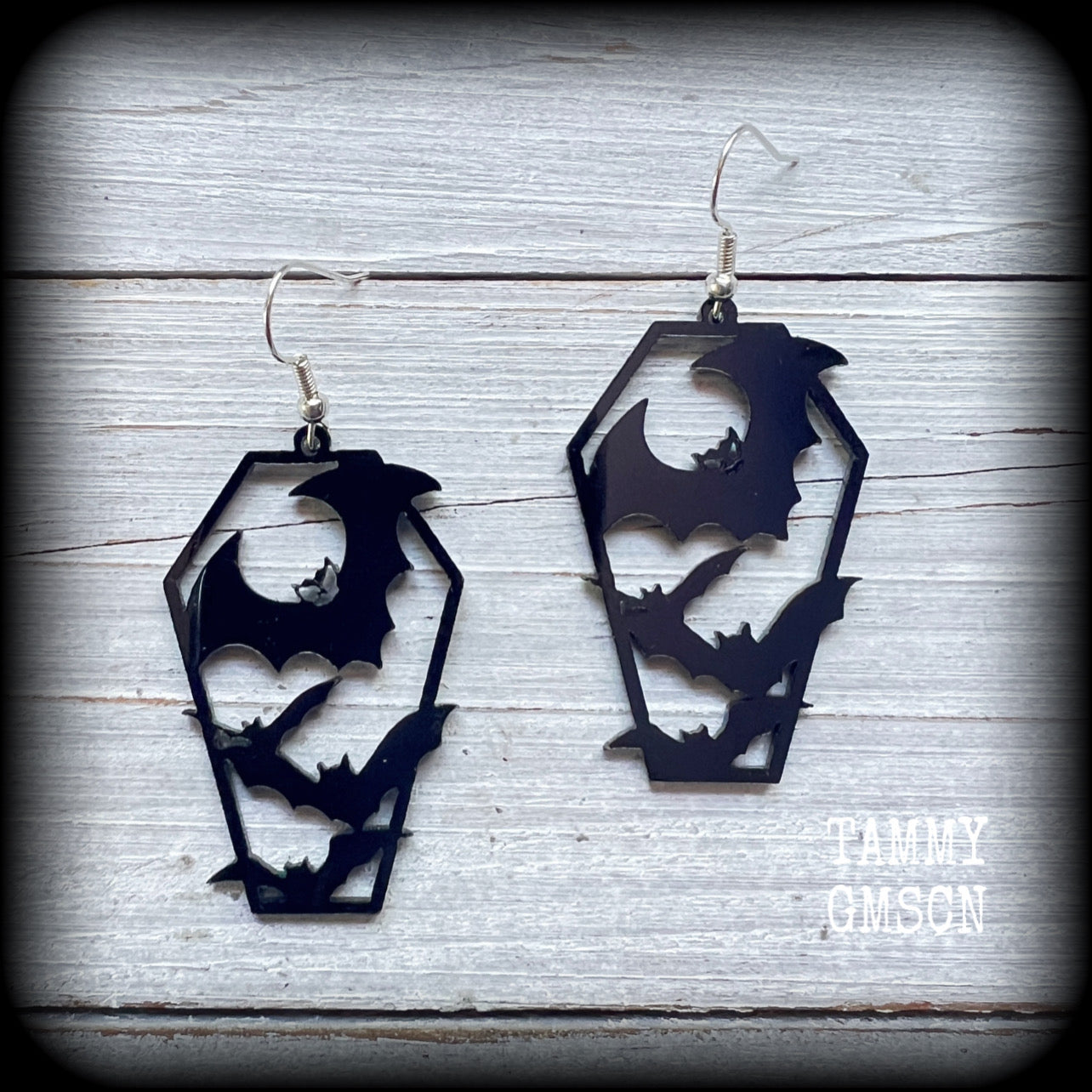 These awesome earrings feature pitch black acrylic coffins filled with bats! These earrings measure just over 6 cms from tip to tip and are nice and lightweight at only a few grams each.

This pair have been made on stainless steel french hooks, to be worn in pierced ears.