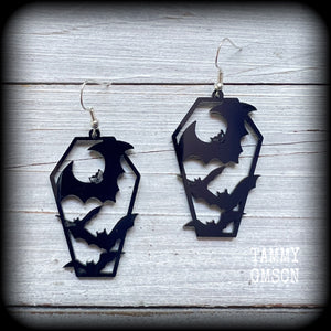 These awesome earrings feature pitch black acrylic coffins filled with bats! These earrings measure just over 6 cms from tip to tip and are nice and lightweight at only a few grams each.

This pair have been made on stainless steel french hooks, to be worn in pierced ears.
