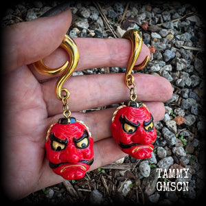 These unique earrings feature bright red painted resin tengu masks, measuring just on 7.5cms from tip to tip and weighing approx 25 grams each.
This pair has been made on 0 gauge (8mm) surgical steel full curl hooks, suitable for stretched lobes.