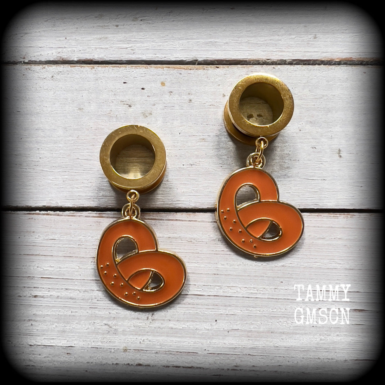 These adorable tunnel earrings feature classic enamel and antique gold pretzel charms, weighing approx 5 grams each, and measuring just over 4 cms from tip to tip.

This pair has been made with 1/2” gauge (12mm) surgical steel screw fit tunnels, to be worn in stretched lobes.