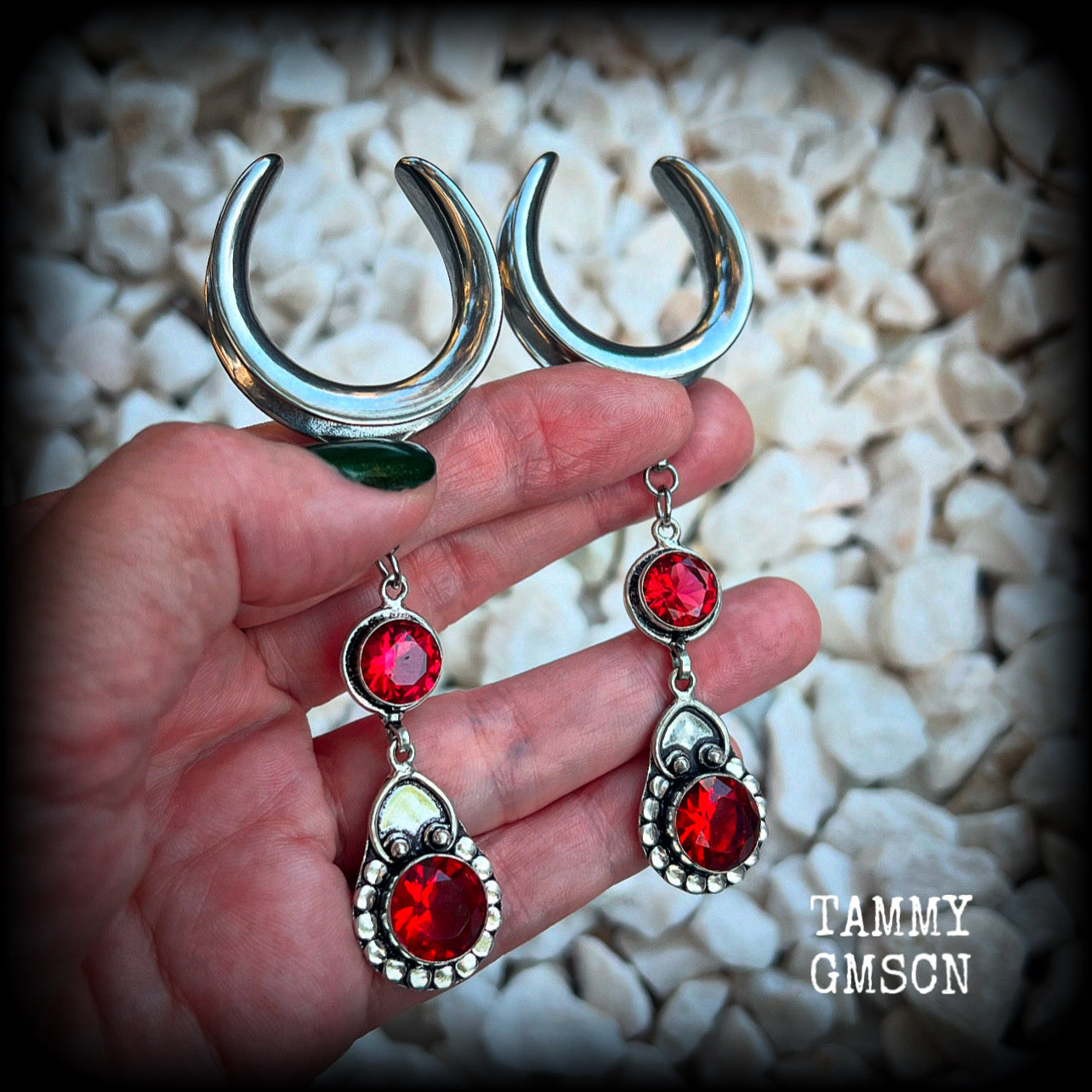 These beautiful boho Garnet ear hangers are made with gorgeous facet gemstones in a beautiful boho antique silver setting, measuring just on 10cm from tip to tip, and weighing 18 grams each, nice and lightweight. 

These earrings have been made on 1.18" gauge (30mm) surgical steel cradles, to be worn in stretched lobes.
