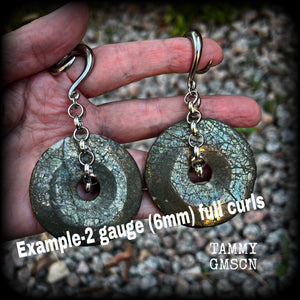 These beautiful big gauged earrings feature gorgeous Pyrite donut gemstones cradles in chunky antique silver chain, measuring just over 9cms from tip to tip, and weighing approx 55 grams each.

This pair has been made on 2 gauge (6mm) surgical steel full curls, to be worn in stretched lobes.