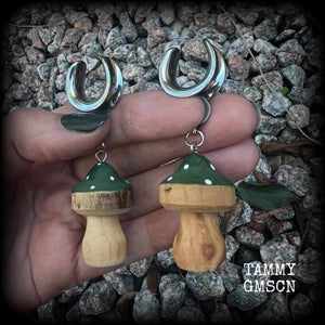 This pair of earrings features gorgeous forest green wood mushrooms, nice and light weight at 8 grams a piece, and nice and dangly at just on 7cms.

This pair has been made on 5/8” gauge (16mm) surgical steel cradles, suitable for stretched lobes.

