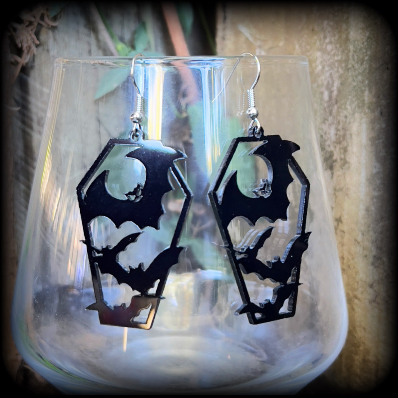 These awesome earrings feature pitch black acrylic coffins filled with bats! These earrings measure just over 6 cms from tip to tip and are nice and lightweight at only a few grams each.

This pair have been made on stainless steel french hooks, to be worn in pierced ears.