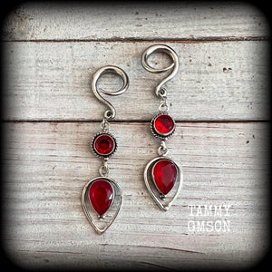 These beautiful gauged earrings feature gorgeous deep red faceted garnet gemstones in an ornate antique silver setting, measuring 7cms from tip to tip, and weighing approx 10 grams each, nice and light weight.

These earrings have been made on 6 gauge (4mm) surgical steel full curl hooks, to be worn in stretched lobes.