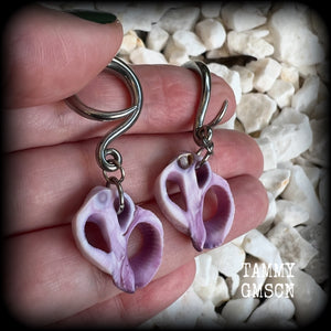 These gorgeous gauged earrings feature beautiful purple sea shell slices, weighing in approx 5 grams a piece, and measuring approx 5.5cms from tip to tip.

This pair has been made on 6 gauge (4mm) surgical steel full curl hooks, to be worn in stretched lobes.