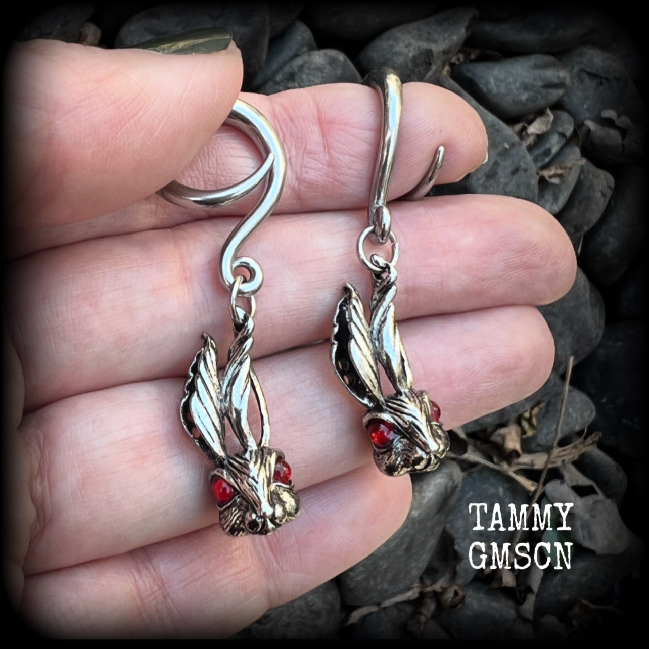 Featuring super cute, slightly creepy antique silver zombie rabbits complete with red eyes, these earrings weigh 7 grams each, and are lovely and dangly at approx 5.5cms from tip to tip.

This pair has been made on 6 gauge (4mm) surgical steel full curl hooks, to be worn in stretched lobes.