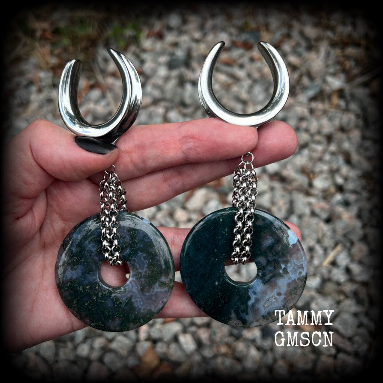 This pair of gorgeous gauged earrings features a pair of unique moss agate gemstone donuts cradled in antique silver chain, weighing approx 39 grams a piece and measuring just over 11cms from tip to tip.

These have been made on 1.18” gauge (30mm) surgical steel cradles, suitable for stretched lobes.