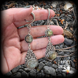 Made with shimmering polished labradorite gemstones, measuring 8.5cms from tip to tip, and weighing approx 10 grams each, not too heavy...
These earrings have been made on 6 gauge (4mm) surgical steel full curl hooks, to be worn in stretched lobes.