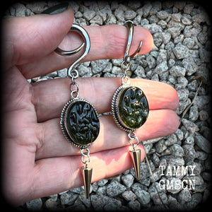 This pair of earrings features gorgeous forest green moldavite gemstones in a boho antique silver setting, weighing approx 10 grams a piece and measuring just on 8cms from tip to tip.  This pair have been made on 6 gauge (4mm) surgical steel full curl hooks, to be worn in stretched lobes.