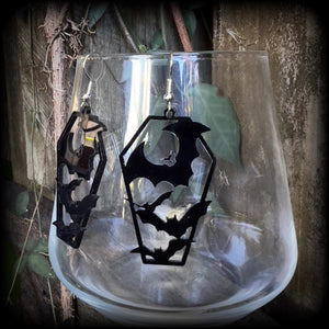 These awesome earrings feature pitch black acrylic coffins filled with bats! These earrings measure just over 6 cms from tip to tip and are nice and lightweight at only a few grams each.

This pair have been made on stainless steel french hooks, to be worn in pierced ears.