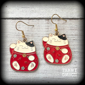 Featuring red and white maneki neko cat charms, theses earrings measure just under 5cms from tip to tip, and weigh only a few grams each.

This pair have been made with antique gold french hooks, suitable for pierced ears.