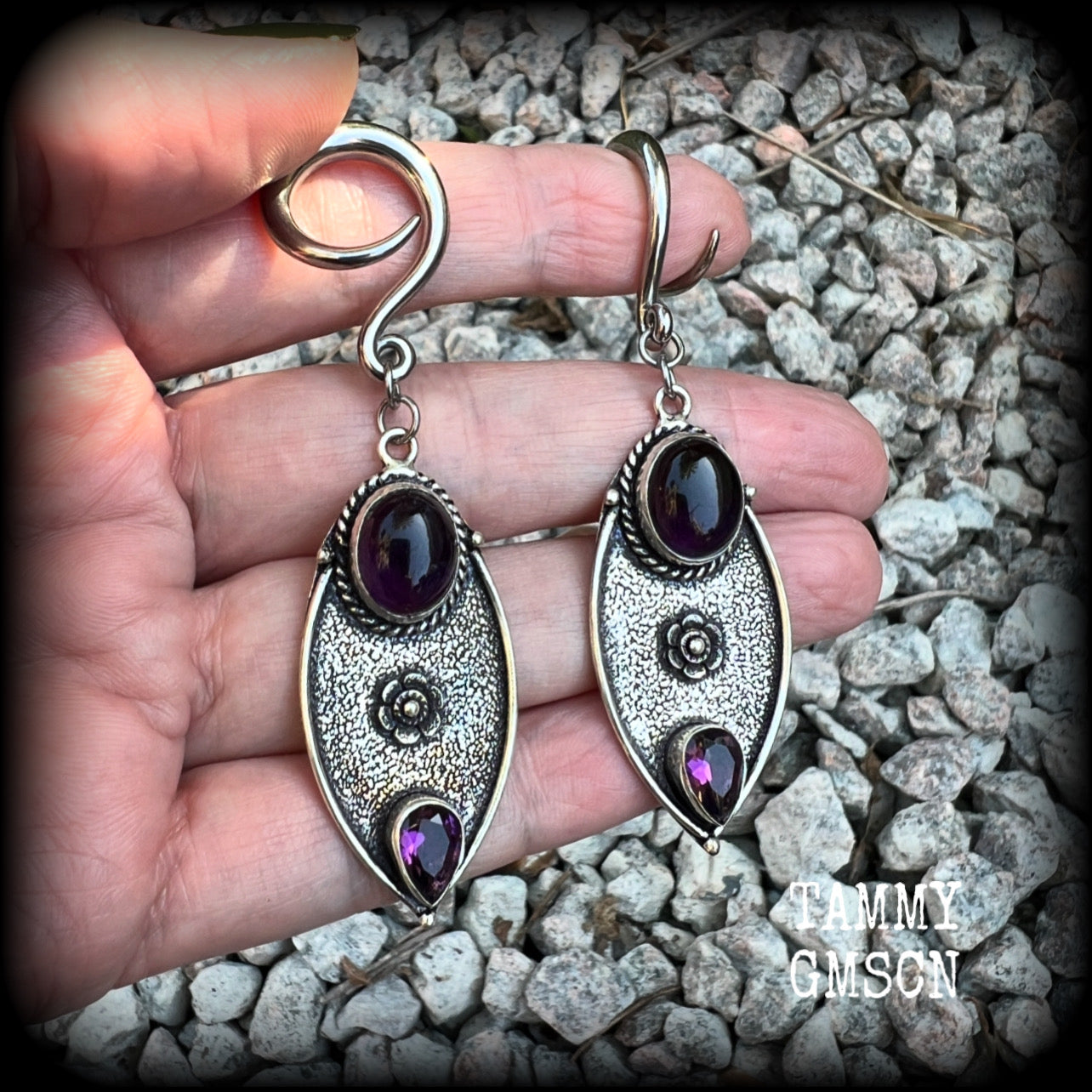 Featuring beautiful purple amethyst gemstones in a boho antique silver setting , this pair of earrings weighs approx 8 grams a piece and measure just under 8cms from tip to tip.

This pair have been made on 6 gauge (4mm) surgical steel full curl hooks, to be worn in stretched lobes.