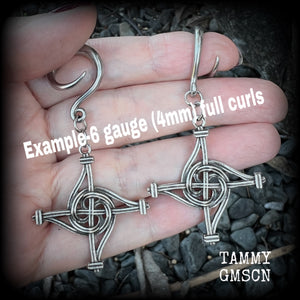 These gorgeous gauged earrings feature antique silver interwoven Brigids crosses, measuring approx 7.5cms from tip to tip, and weighing approx 7 grams each.

This pair has been made on 6 gauge (4mm) surgical steel full curl hooks, suitable for stretched lobes.