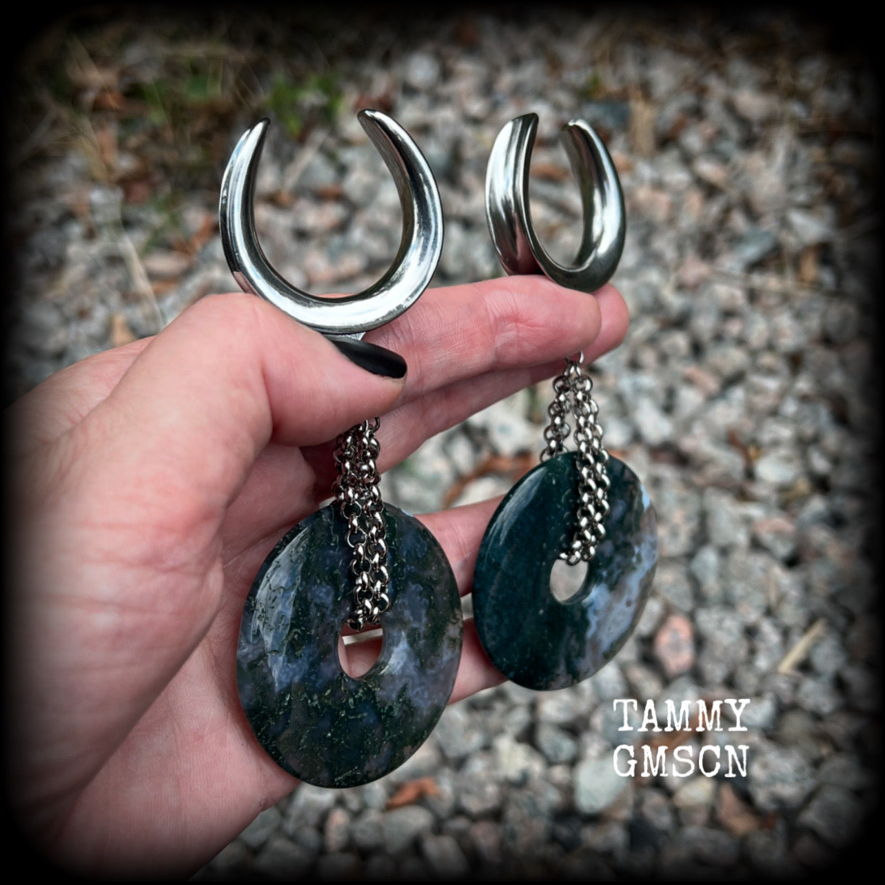 This pair of gorgeous gauged earrings features a pair of unique moss agate gemstone donuts cradled in antique silver chain, weighing approx 39 grams a piece and measuring just over 11cms from tip to tip.

These have been made on 1.18” gauge (30mm) surgical steel cradles, suitable for stretched lobes.
