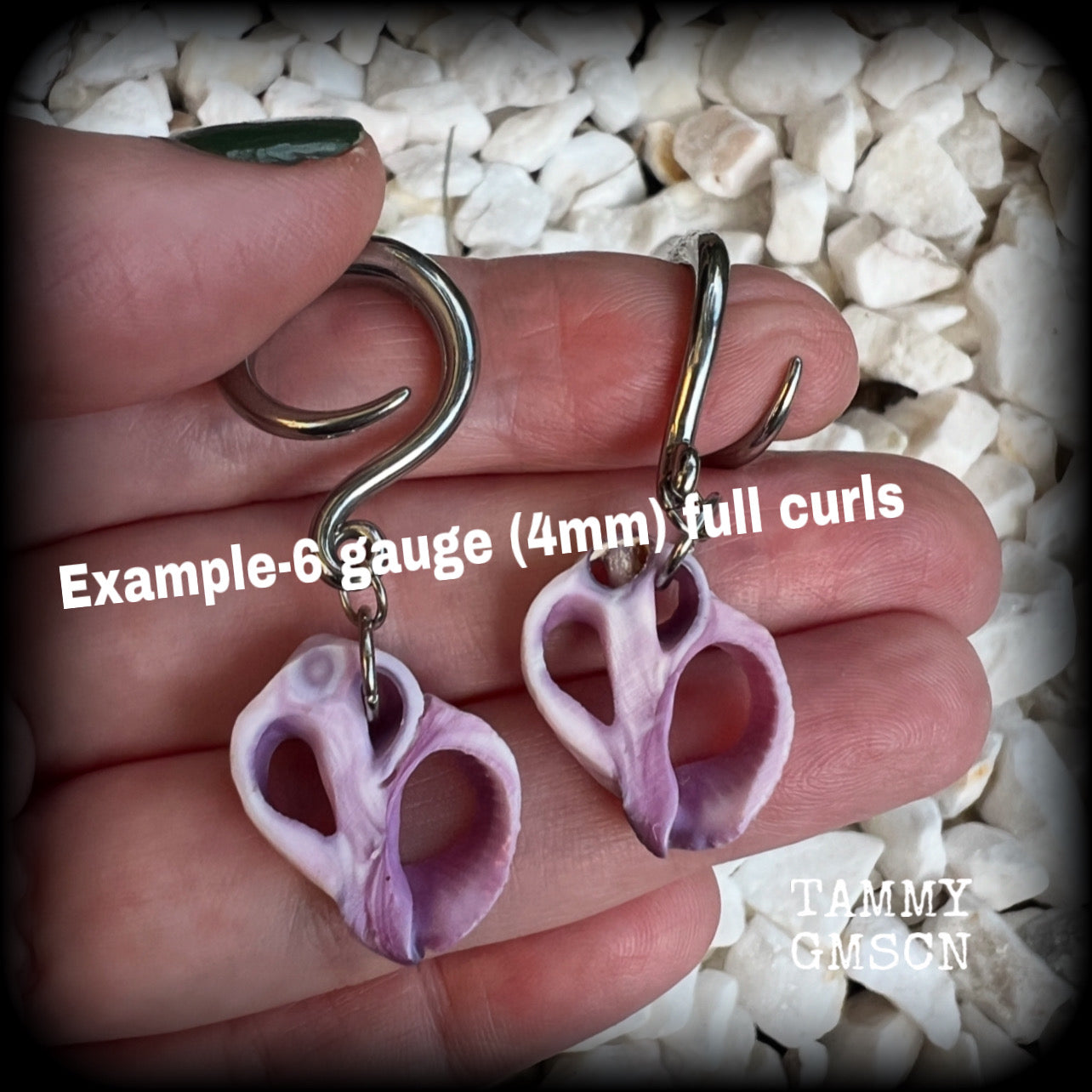 These gorgeous gauged earrings feature beautiful purple sea shell slices, weighing in approx 5 grams a piece, and measuring approx 5.5cms from tip to tip.

This pair has been made on 6 gauge (4mm) surgical steel full curl hooks, to be worn in stretched lobes.