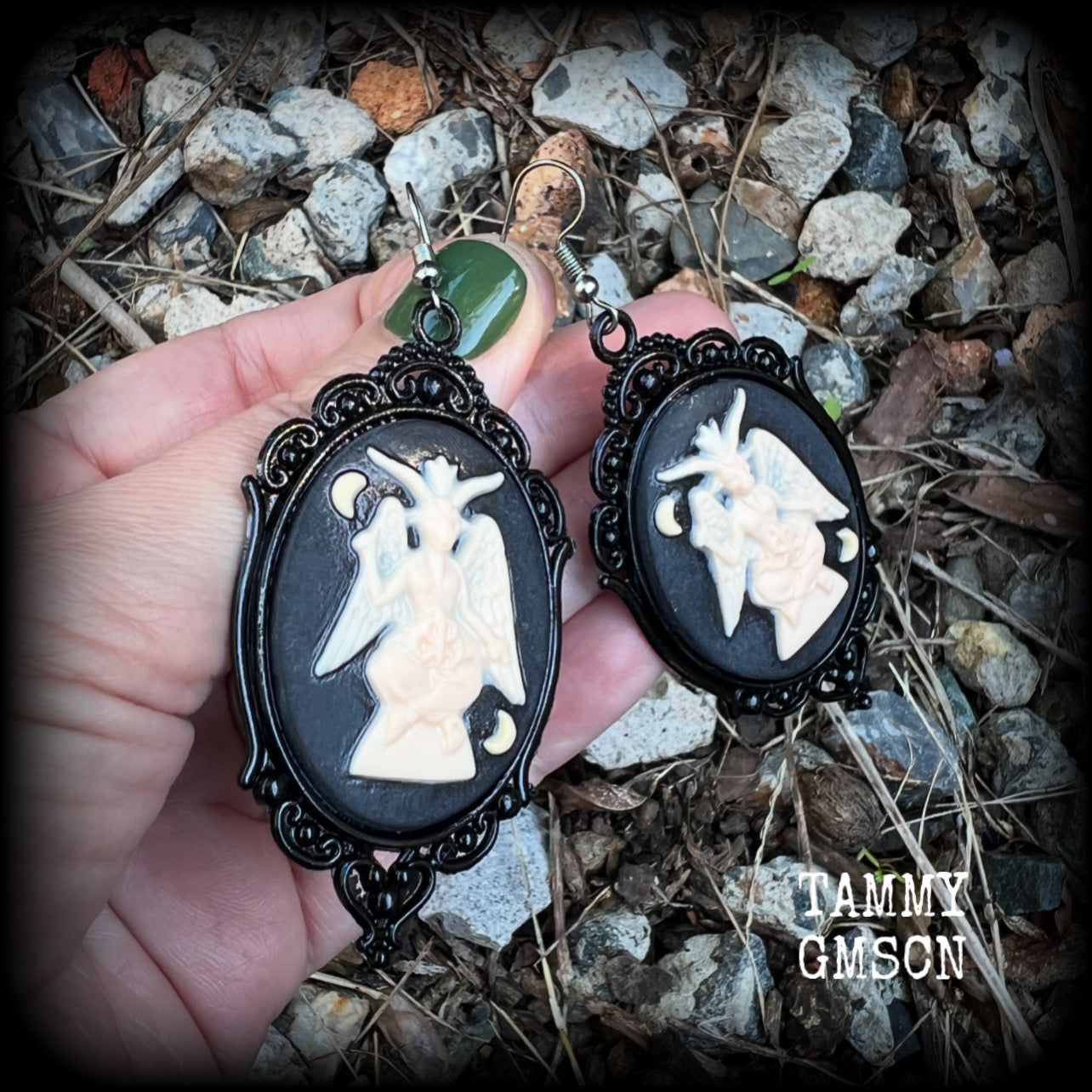 These gorgeous gothic earrings feature ivory Baphomets enclosed in beautiful black enamel framea, are light weight (11 grams a piece) and nice and dangly, measuring just over 8cms from tip to tip.

This pair has been made on stainless steel french hooks, suitable for pierced ears.

