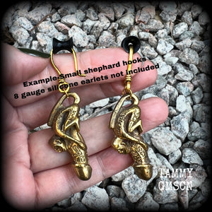 Featuring a brass Paladkhik penis charm, worn to attract love sex wealth and success and to protect from evil, these unique earrings weigh 19 grams each and measure just over 6cms from tip to tip.

This pair have been made on small antique antique gold shephard hooks, to be worn through stretched ears with silicone earlets from 8 gauge (3mm).