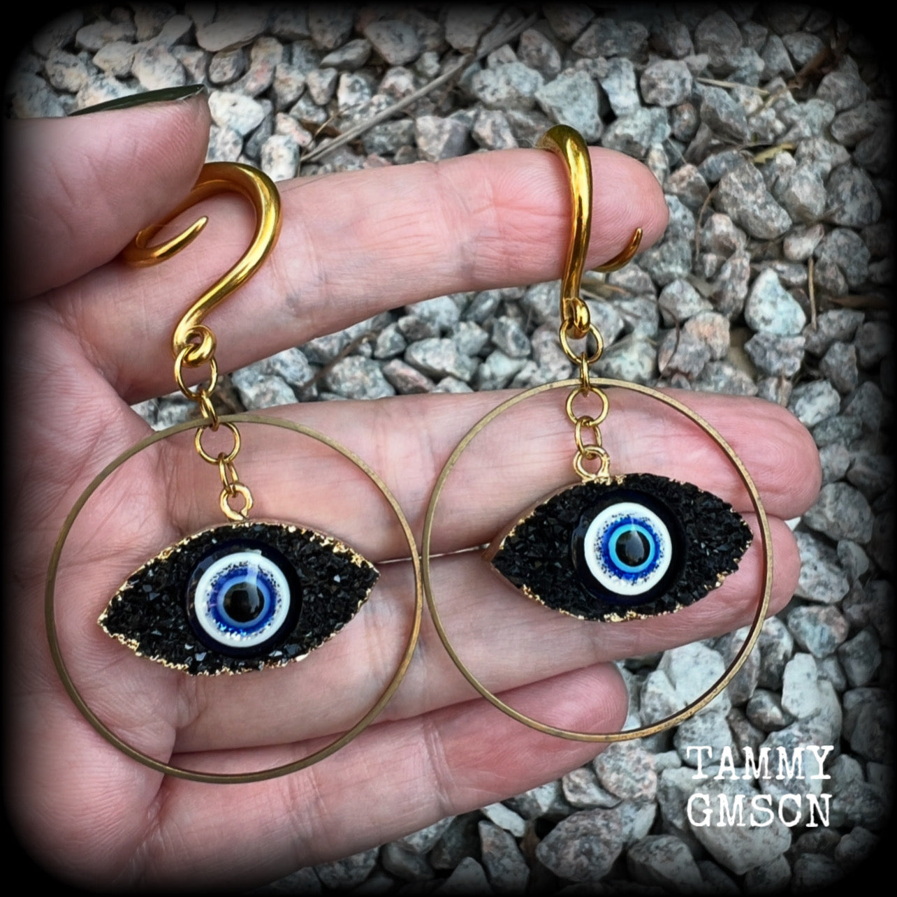 These unique evil eye gauged earrings feature a faux druzy greek evil eye, weighing approx 6 grams each, and are nice and dangly, hanging just on 7cms from tip to tip.

This pair have been made on 6 gauge (4mm) surgical steel full curl hooks, suitable for stretched lobes.
