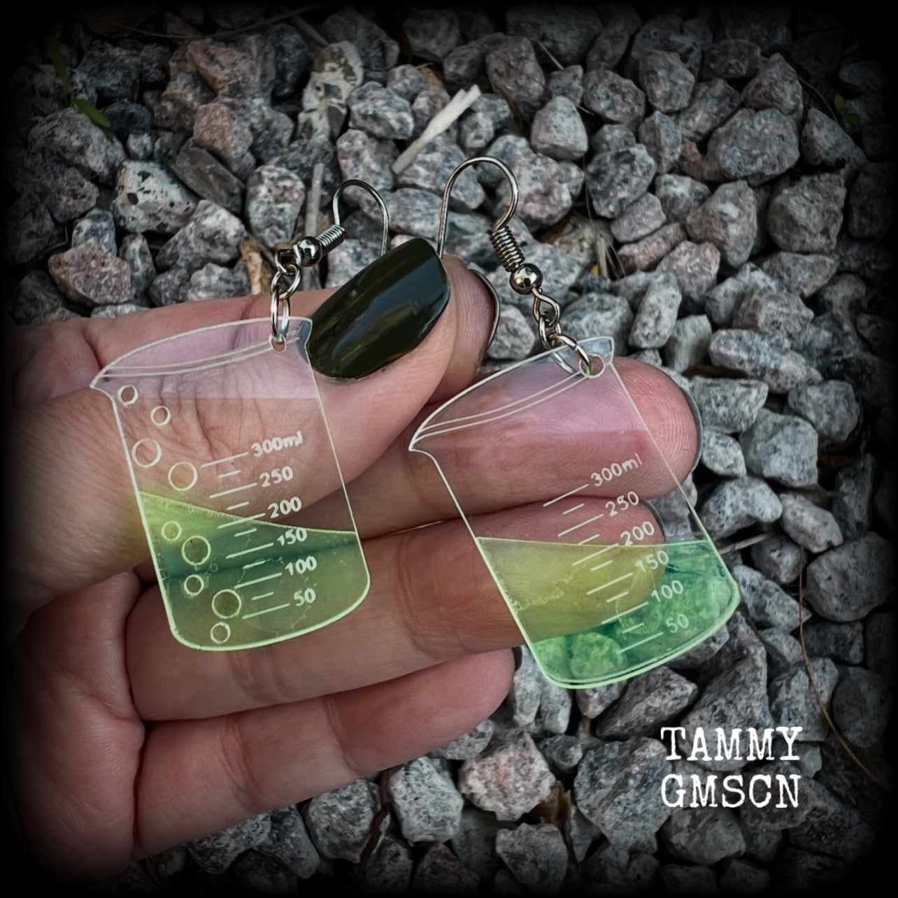 This pair of earrings features a pair of absolutely adorable classic Griffin chemistry beakers full of bubbly green liquid, measuring just under 6cms from tip to tip and weighing only a few grams each.

This pair have been made on stainless steel french hooks, suitable for pierced ears.