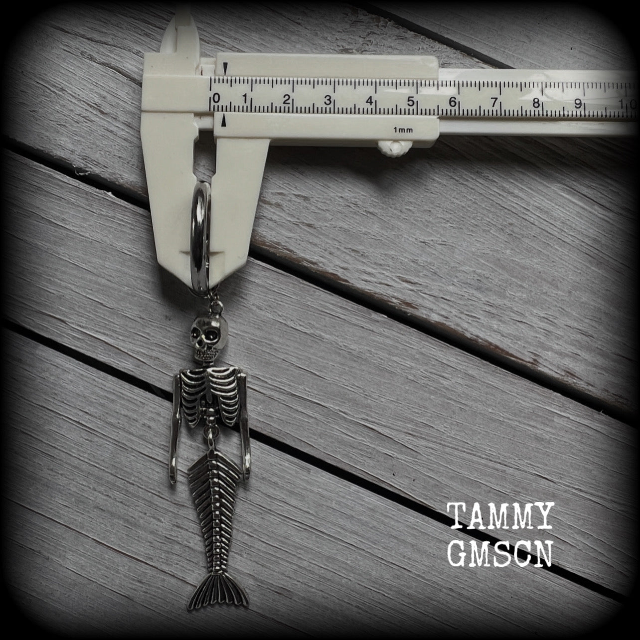 These gorgeous dangly earrings feature antique silver mermaid skeletons, measuring approx 10.5 cms from tip to tip, and weighing approx 14 grams a piece .

These earrings have been made on strong silver alloy snap hoop rings, to be worn in stretched lobes with silicone earlets from 2 gauge (6mm).