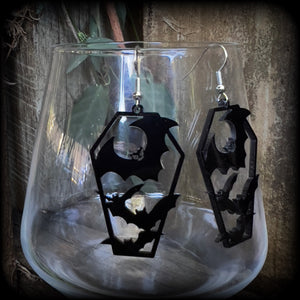 These awesome earrings feature pitch black acrylic coffins filled with bats! These earrings measure just over 6 cms from tip to tip and are nice and lightweight at only a few grams each.

This pair have been made on stainless steel french hooks, to be worn in pierced ears.