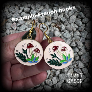 These adorable antique gold and enamel toadstool earrings measure in at just under 5cm, are nice and light, weighing only a few grams each.

This pair has been made with antique gold french hooks, suitable for pierced ears.
