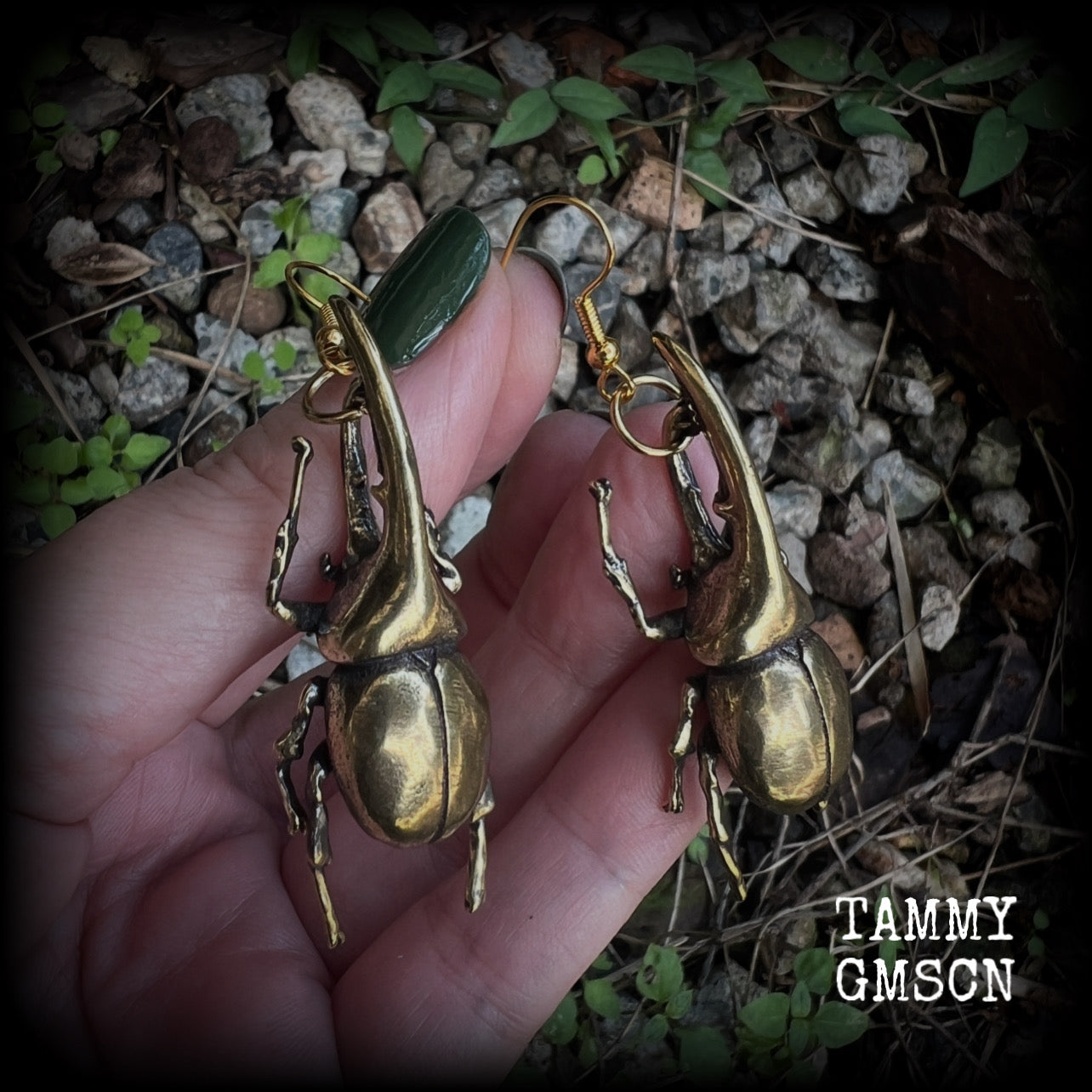 These gorgeous brass Hercules beetle earrings are big and beautiful! Weighing approx 19 grams each, this pair measures 7cms from tip to tip.

This pair has been made on antique gold french hooks, suitable for pierced ears.