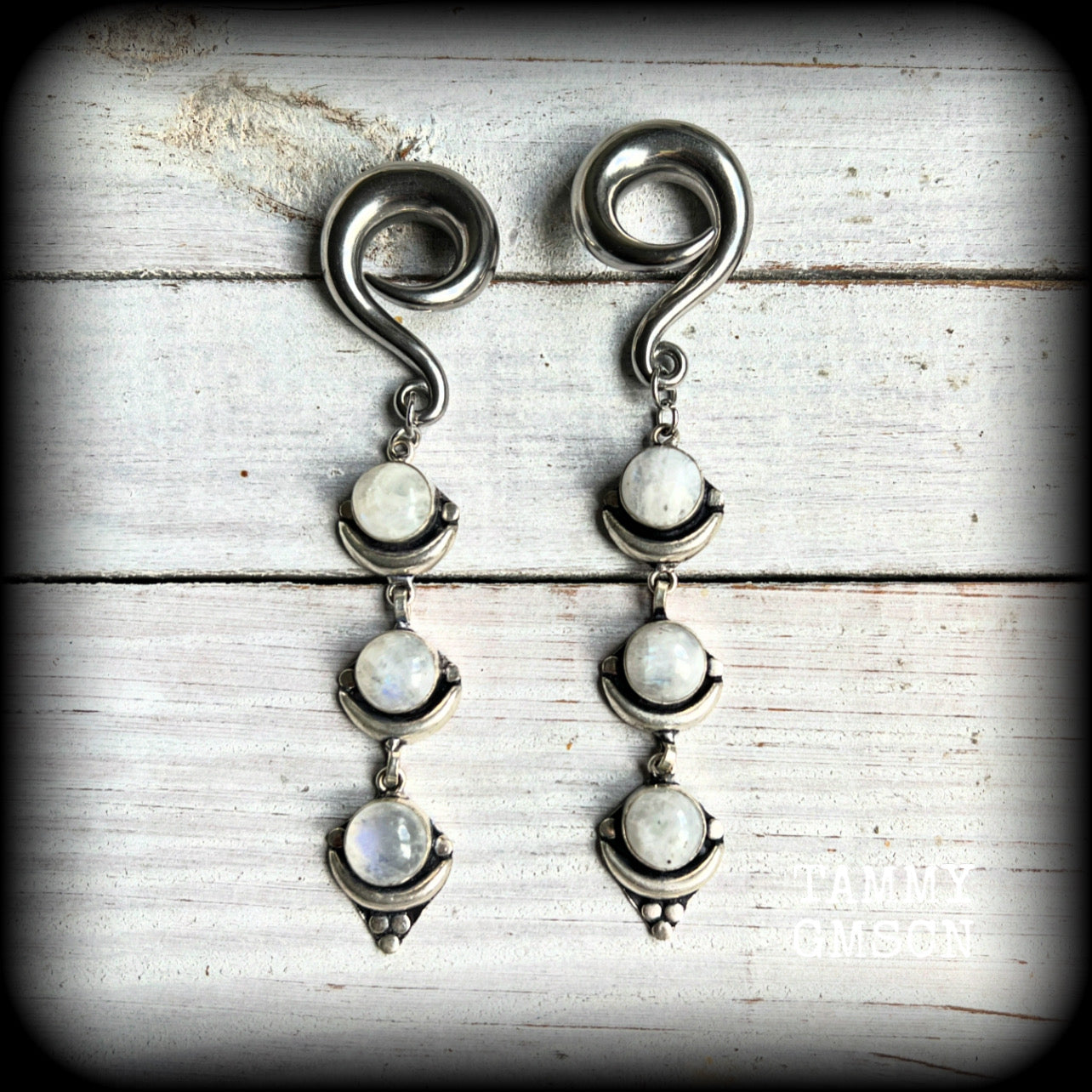 These beautiful boho Rainbow moonstone earrings are made with gorgeous polished gemstones, lovely and dangly measuring approx 10cms from tip to tip, and weighing approx 21 grams each. 

These earrings have been made on 00 gauge (10mm) surgical steel full curl hooks, to be worn in stretched lobes.