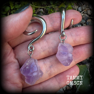 These gorgeous gauged earrings feature beautiful purple raw amethyst gemstones, measuring just under 6cms from tip to tip, and weighing approx 10 grams each, not too heavy...

This pair have been made on 2 gauge (6mm) surgical steel full curl hooks, to be worn in stretched lobes.