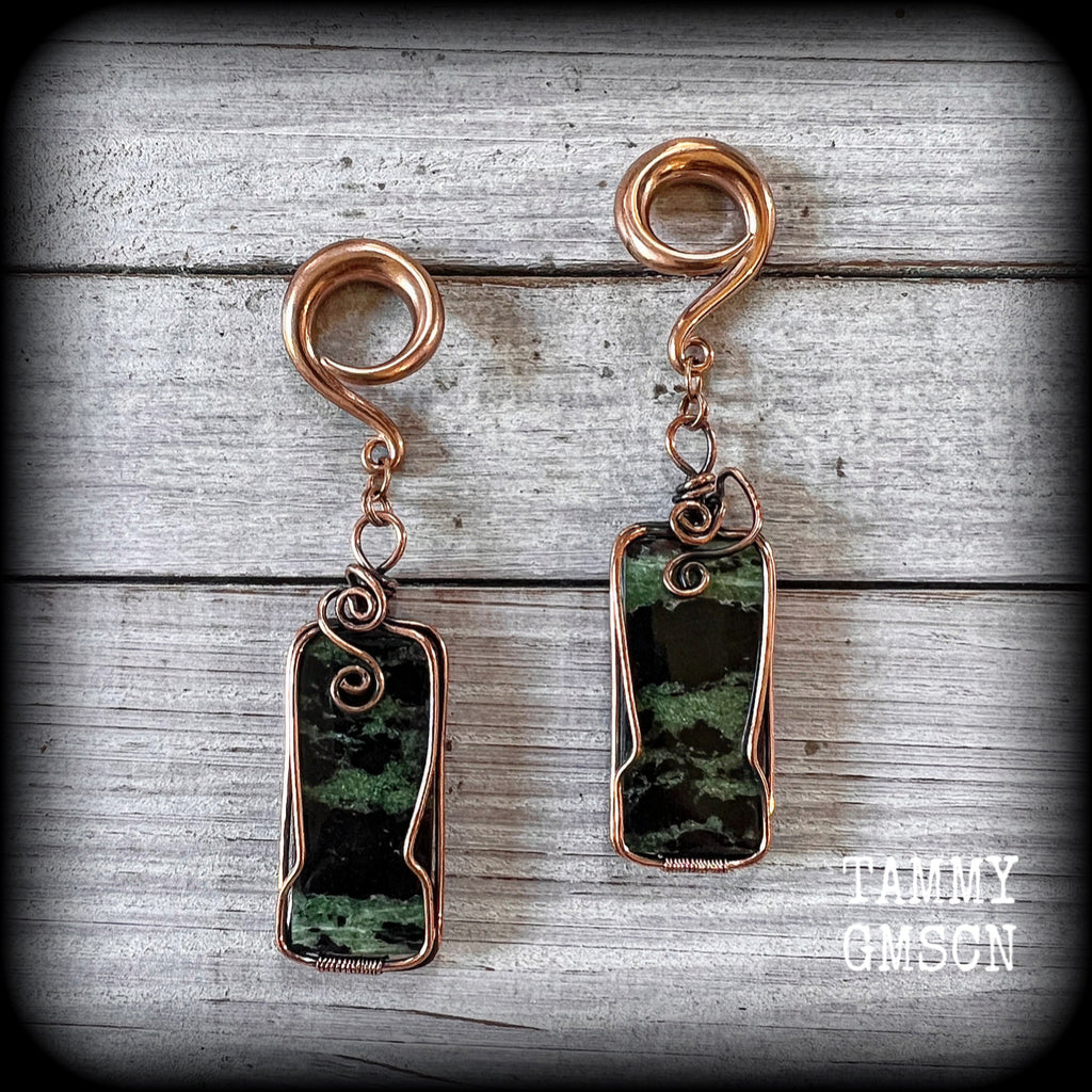 These beautiful steampunk inspired gauged earrings feature gorgeous big rustic wire wrapped ruby zoisite gemstones, measuring 9.5cms from tip to tip, and weighing approx 20 grams each.
This pair has been made on 2 gauge (6mm) titanium coated surgical steel full curl hooks, suitable for stretched lobes.