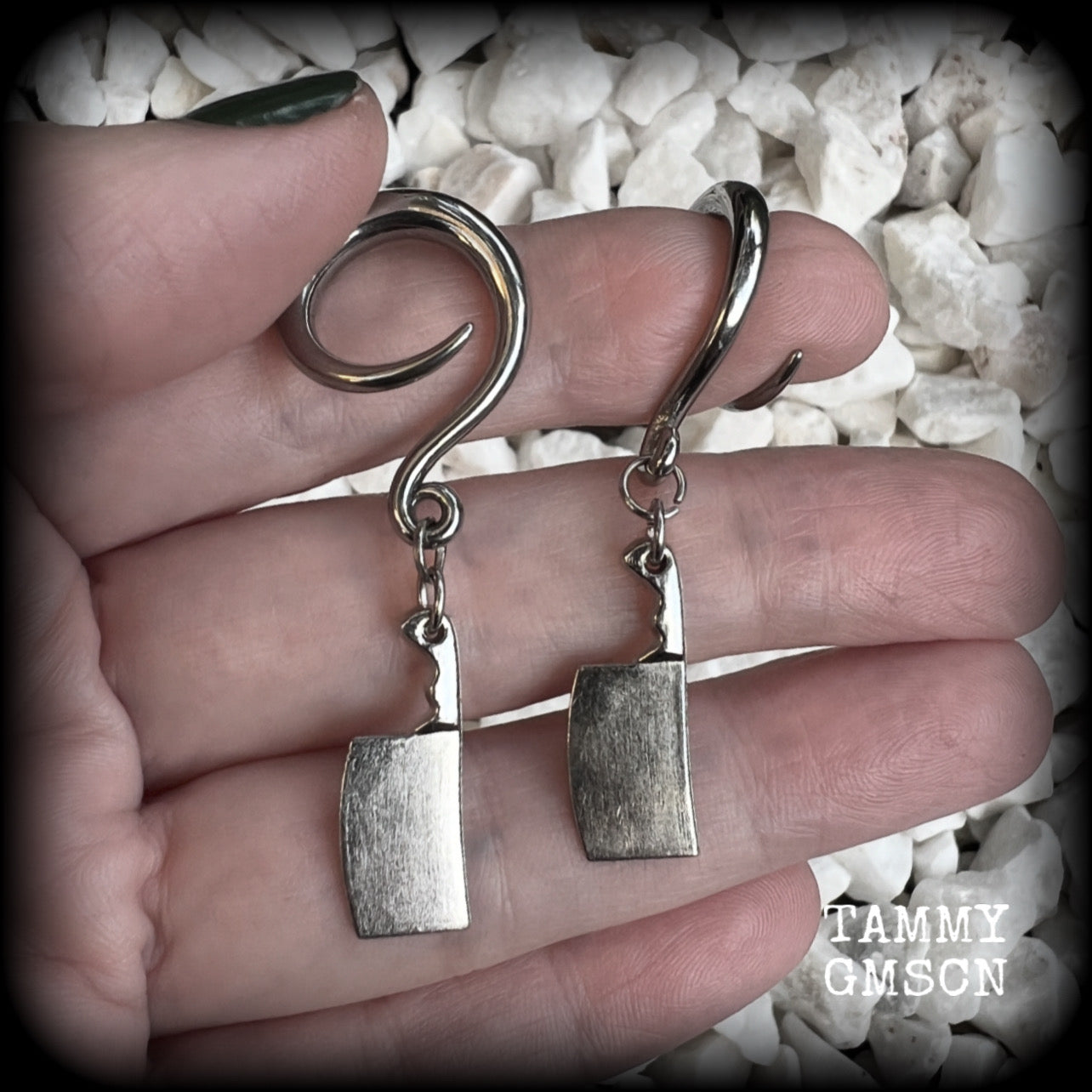 Featuring a pair of awesome antique silver meat cleavers, these earrings are super lightweight, weighing in at only 5 grams a piece, and are nice and dangly at just on 5.5cms.

🩸 Do you want a bit of b l o o d on your meat cleavers? Please just let us know!

This pair has been made on 6 gauge (4mm) surgical steel full curl hooks, to be worn in stretched lobes.